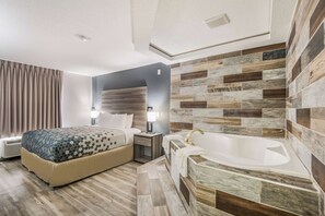 Relax in a stylish room with a large bed, bathtub, and modern amenities.