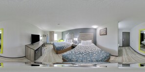 Relax in a stylish room with a large bed, flat-screen TV, and desk area.