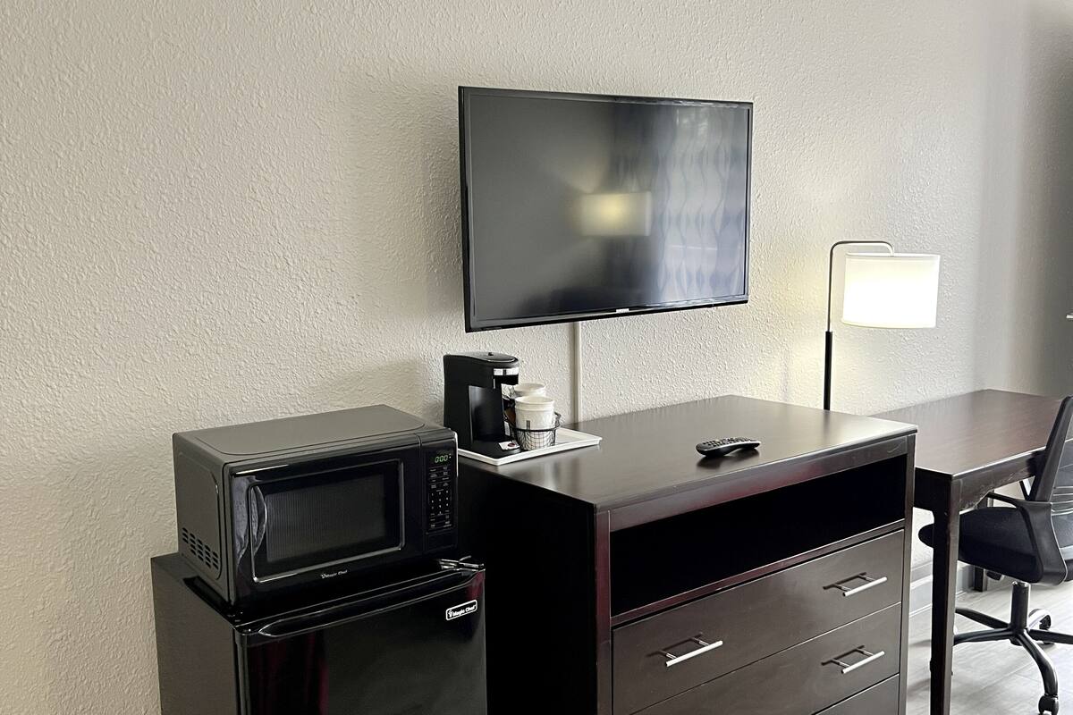 room, 1 king bed, non smoking, pool view | desk, laptop workspace, blackout curtains, iron/ironing board