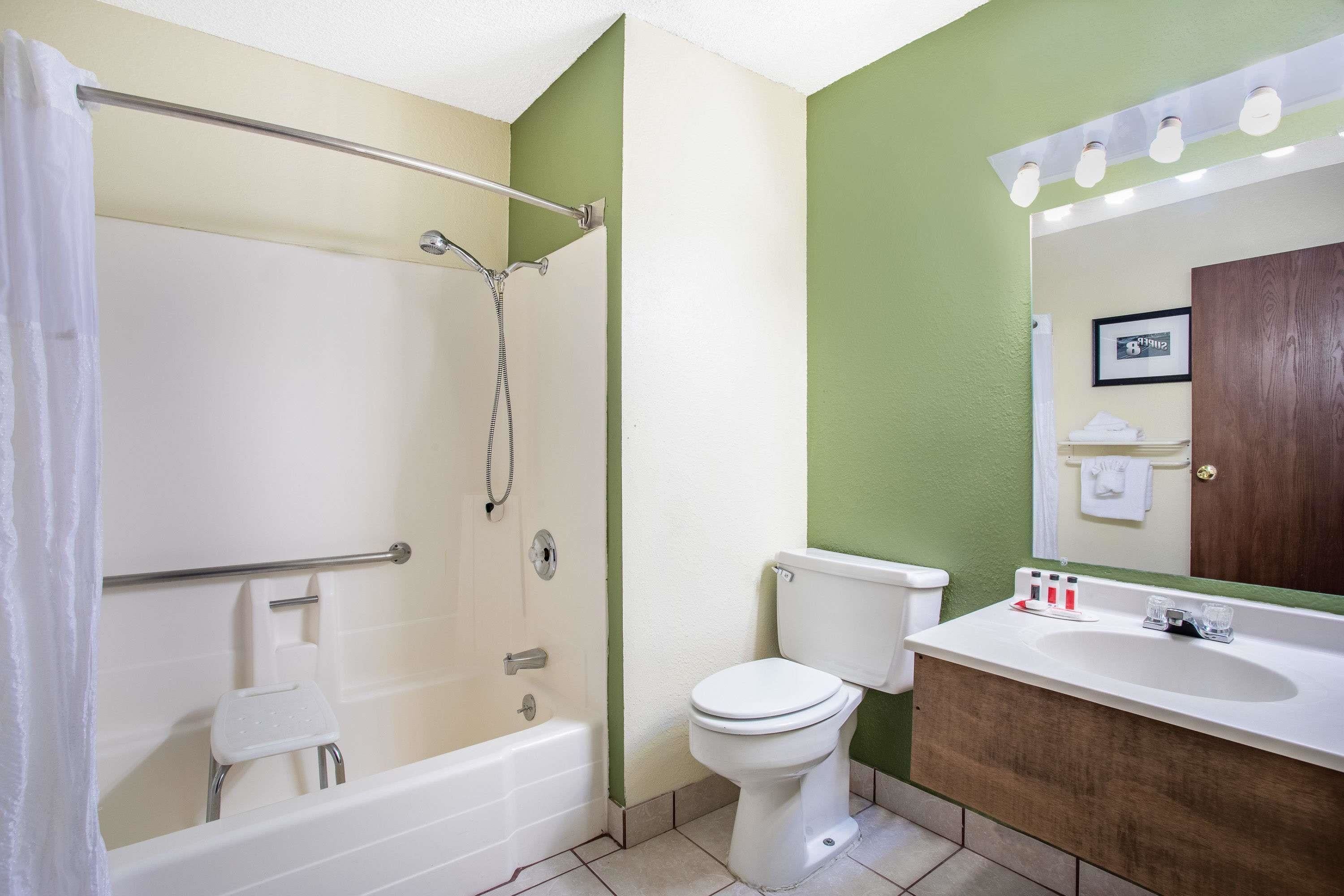 A bathroom with a bathtub, toilet, and sink.