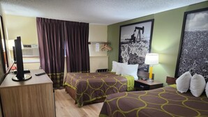 A hotel room with two beds, a desk, a TV, and a window with curtains. - Super 8 by Wyndham Craig (Craig)