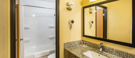 A bathroom with a shower, toilet, and sink.