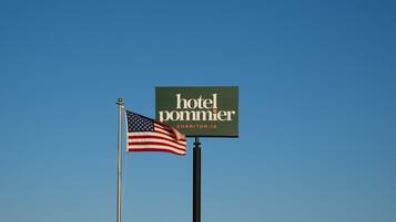 A hotel sign with the name 'hotel pommier' and location 'CHARITON, IA'.