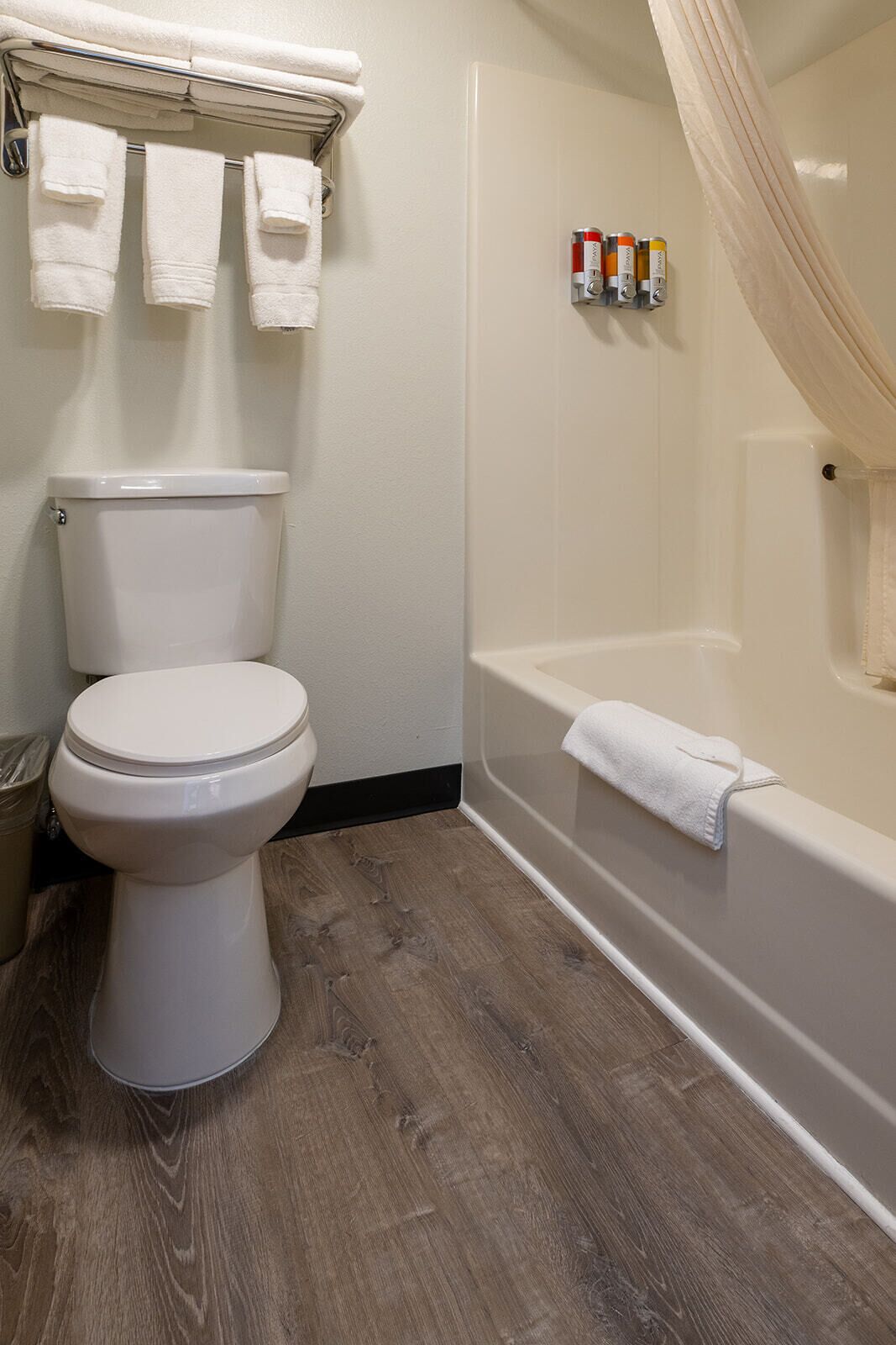 combined shower/bathtub, designer toiletries, hair dryer, towels