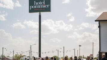 Une enseigne d’hôtel portant le nom « Hotel Pommier » et l’adresse « CHARITON, IA ».