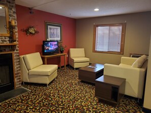 Cozy living room with a fireplace and television for relaxation and entertainment.