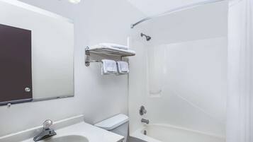 A modern bathroom with a white sink, toilet, and shower.