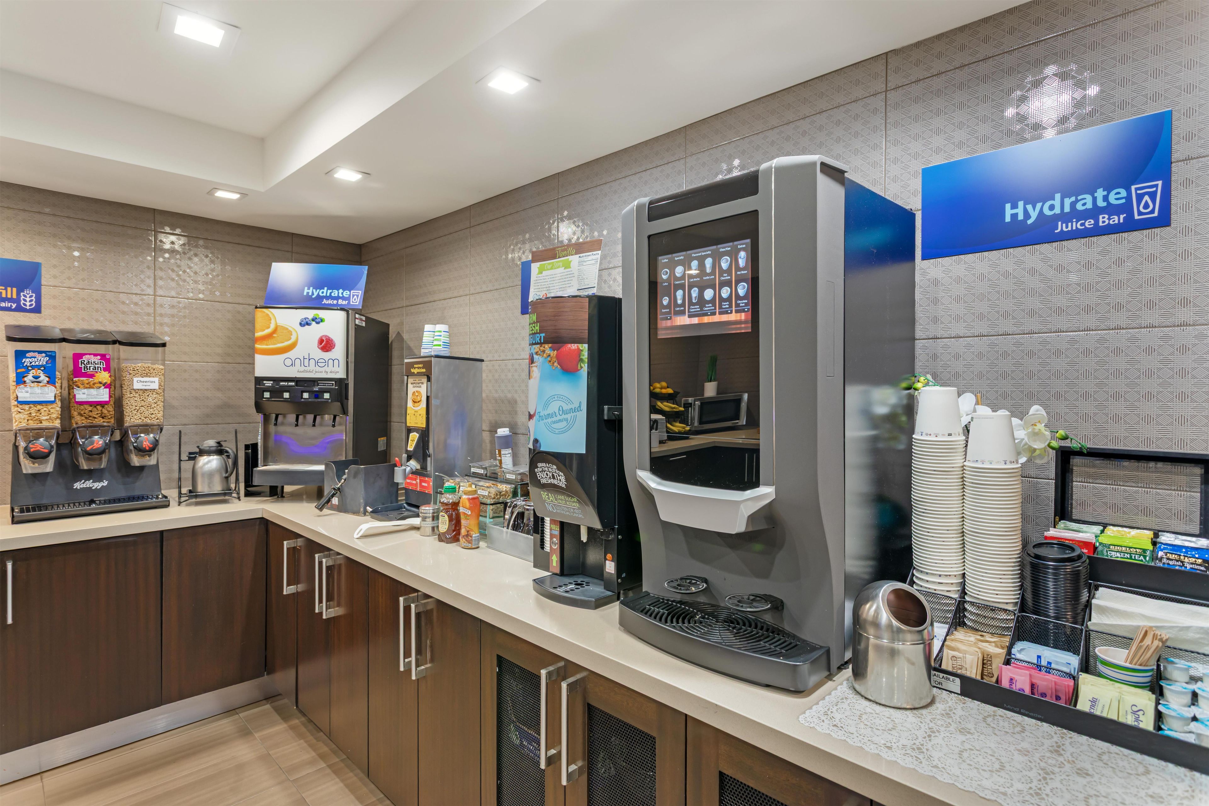 A juice bar with a selection of beverages and a coffee machine.