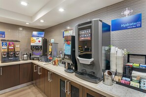 A juice bar with a selection of beverages and a coffee machine.