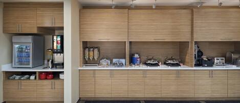 A modern kitchen with wooden cabinets, a refrigerator, and various appliances.