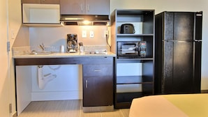 A compact kitchen with a microwave, coffee maker, and a refrigerator. - Studio 6 Extended Stay - Austin, TX - Northwest (Austin)