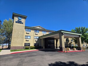 A hotel with a prominent 'Best Western' sign, a covered entrance, and a parking lot.