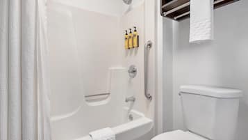 A bathroom with a bathtub, toilet, and shower.