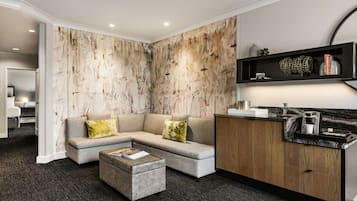 Una sala de estar moderna con un sofá modular gris, un mueble de madera y una encimera de mármol.