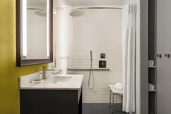 Combined shower/tub, designer toiletries, hair dryer, bathrobes at Hilton Motif Seattle