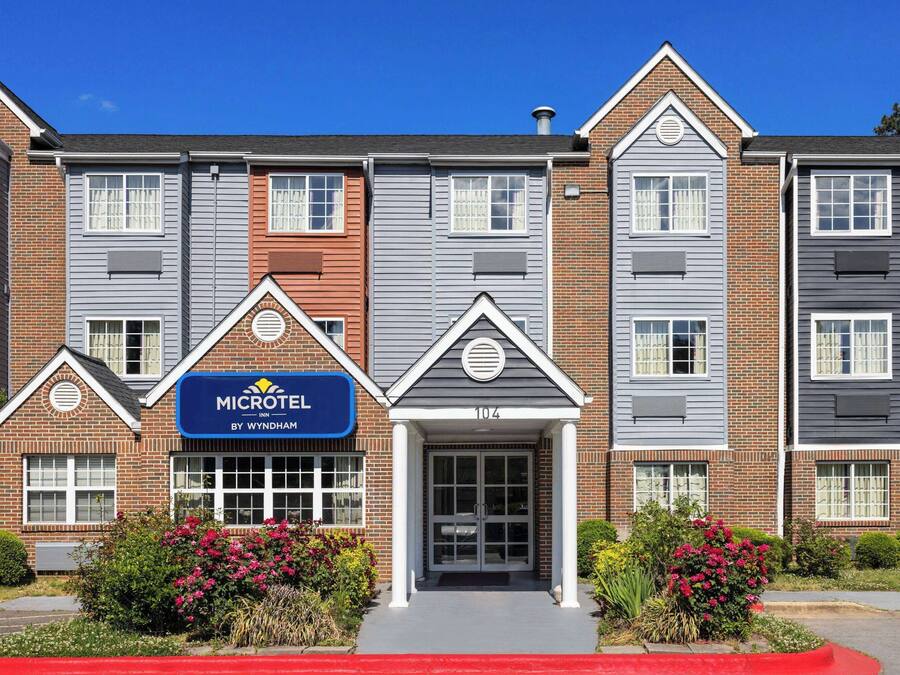 A Microtel Inn by Wyndham with a brick facade, multiple windows, and a prominent entrance.