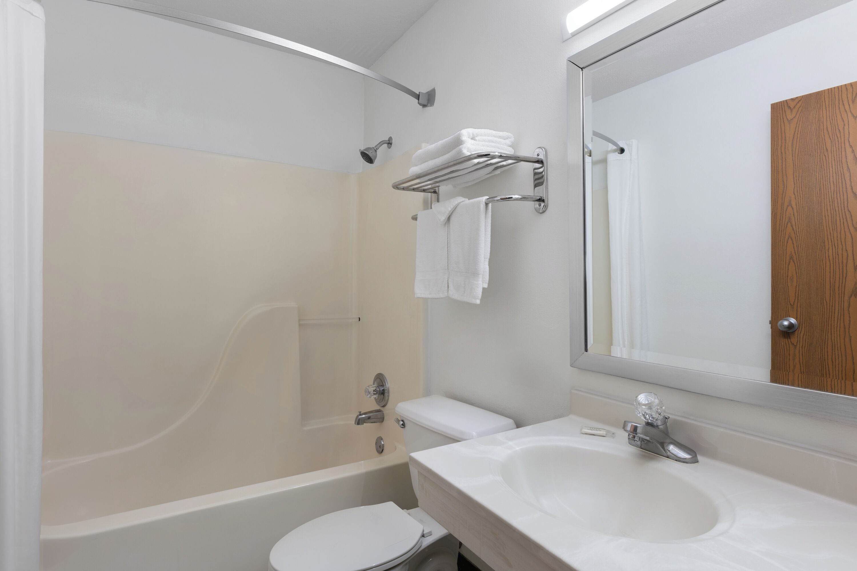 A modern bathroom with a bathtub, toilet, and sink.