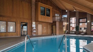 An indoor swimming pool with wooden walls and a 3 FT depth marker.