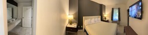 Desk, laptop workspace, blackout drapes, iron/ironing board