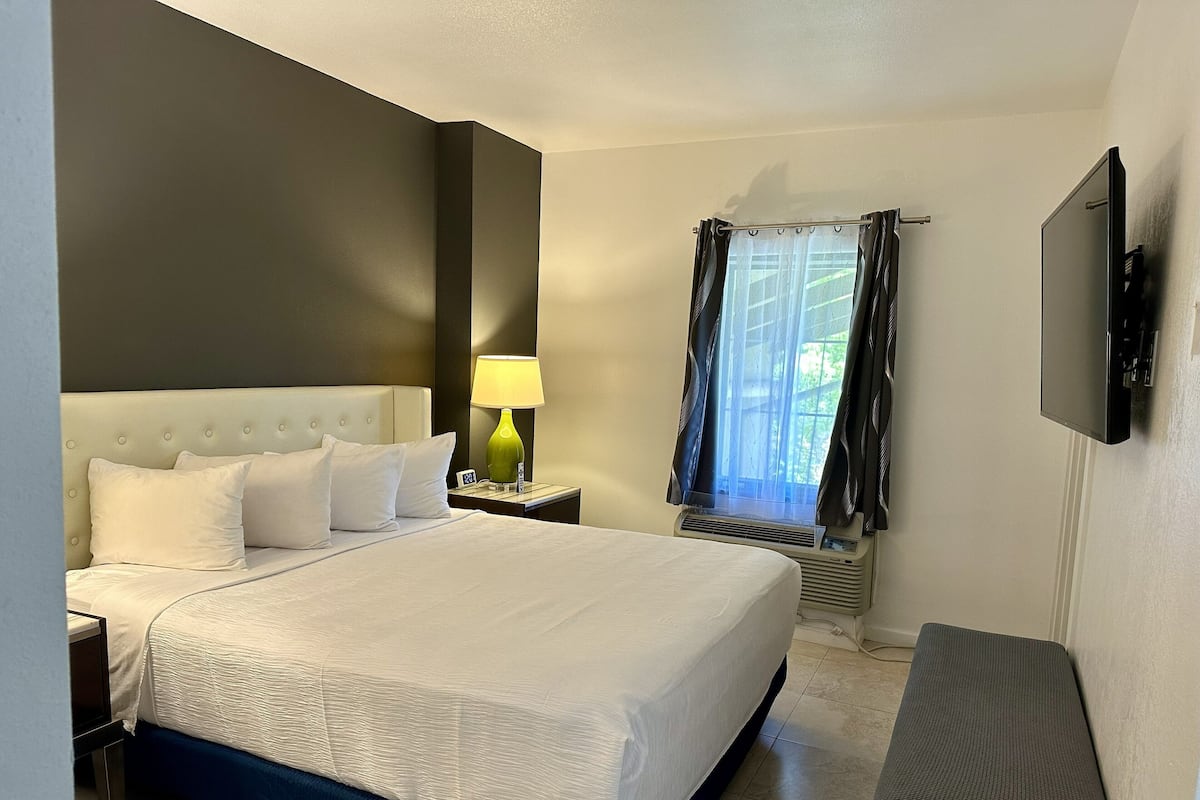 Suite, 1 King Bed, Non Smoking, Jetted Tub (Balcony) | Desk, laptop workspace, blackout curtains, iron/ironing board