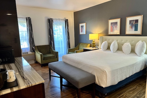 Desk, laptop workspace, blackout drapes, iron/ironing board