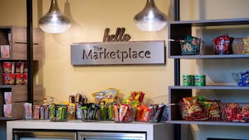 A snack display area in a store with various packaged snacks and a sign that reads "hello The Marketplace".