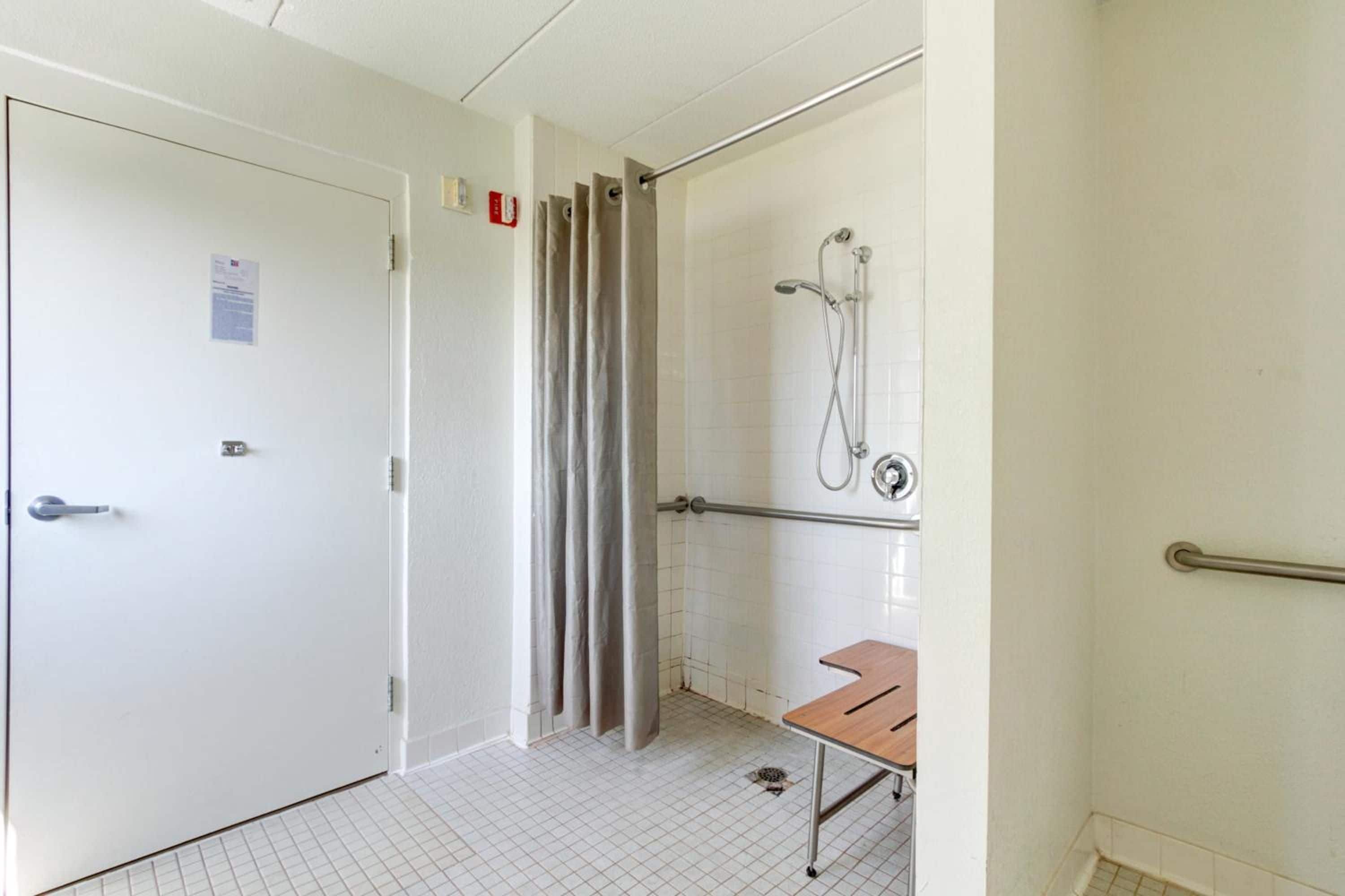 A bathroom with a shower, a toilet, and a sink.