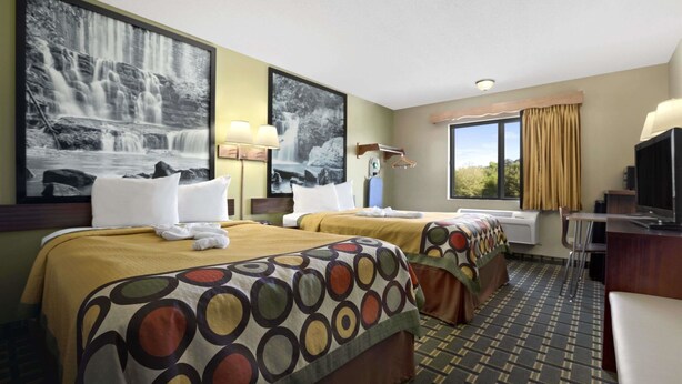 A hotel room with two beds, a desk, a TV, and large windows with curtains. - Super 8 by Wyndham Russellville (Russellville)