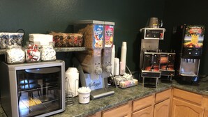 A kitchen area with a refrigerator, coffee machine, and a beverage dispenser. - Super 8 by Wyndham Coeur d'Alene (Coeur d'Alene)