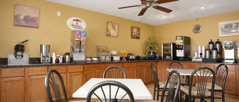 A kitchen with wooden cabinets, a white countertop, and a ceiling fan.