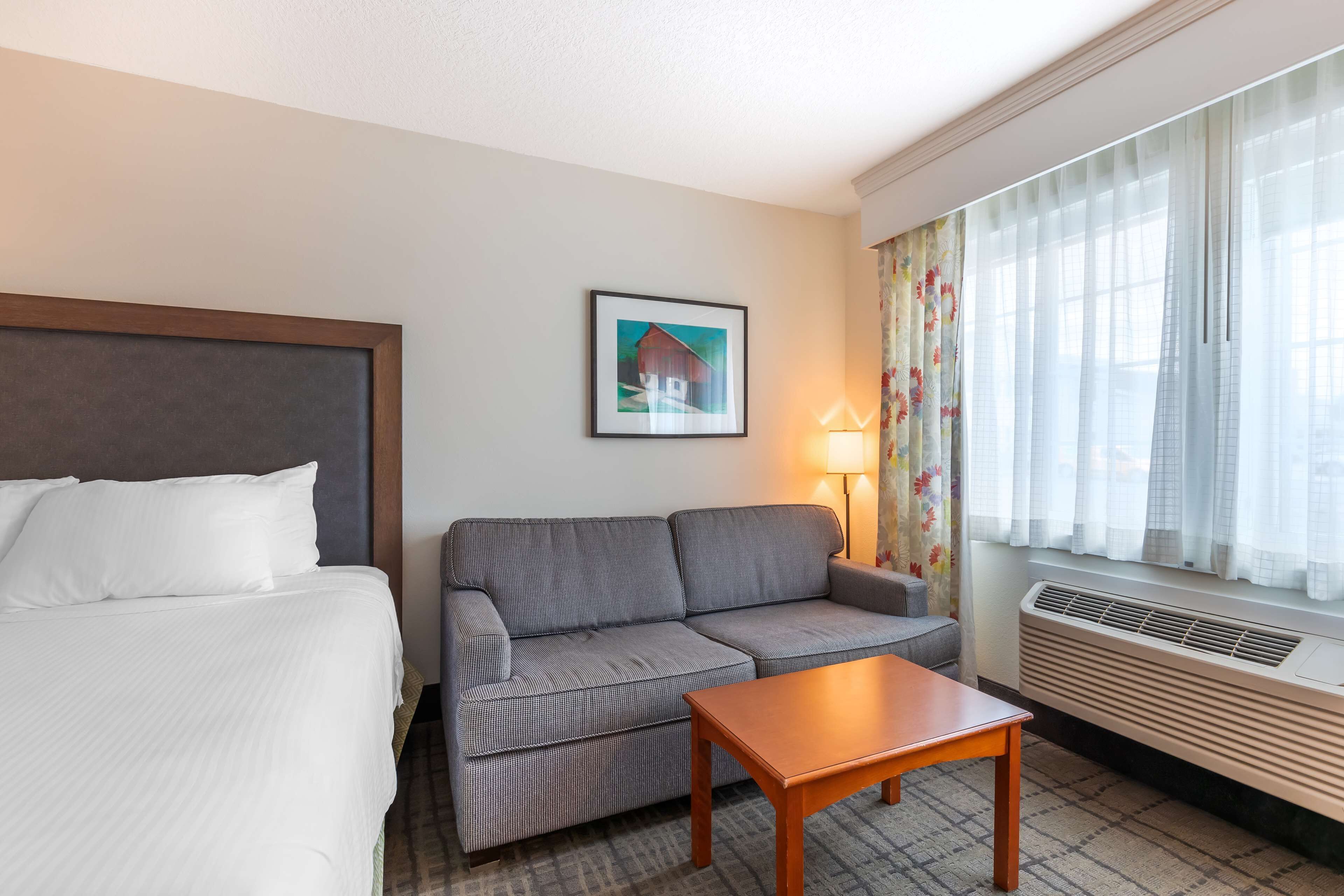 family room, 2 queen beds, non smoking, refrigerator & microwave (pet friendly;with sofabed) | premium bedding, desk, blackout curtains, iron/ironing board