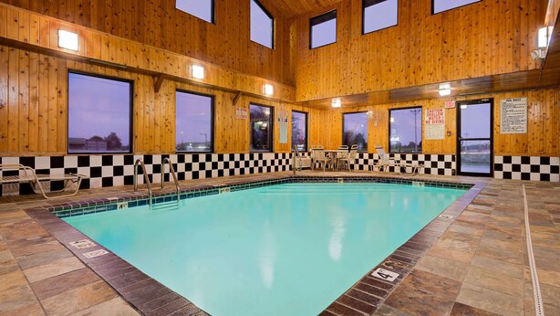 An indoor swimming pool with checkered tiles, wooden walls, and large windows. - Super 8 by Wyndham Iowa Falls (Iowa Falls)