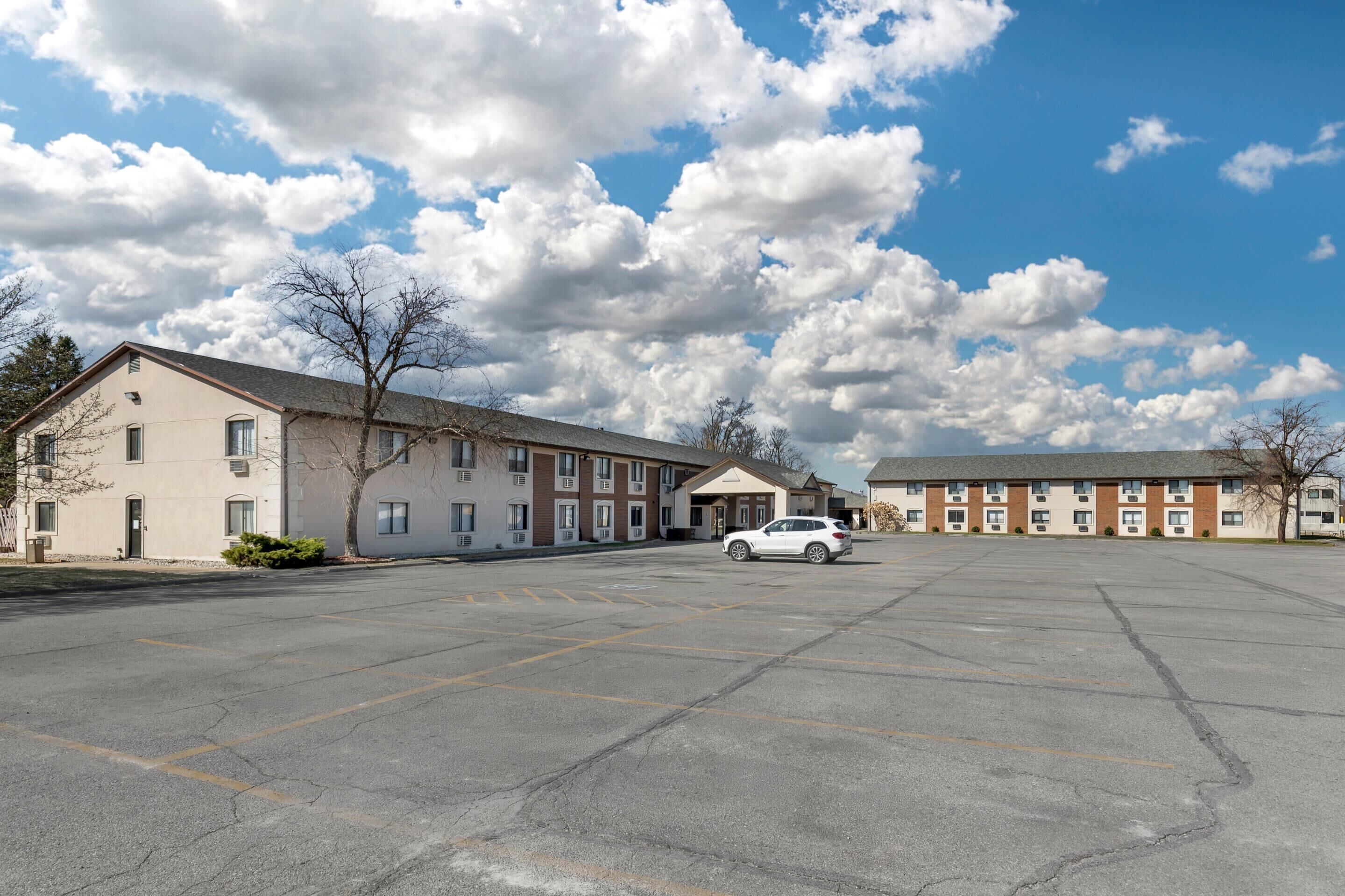 A parking lot with a building in the background.