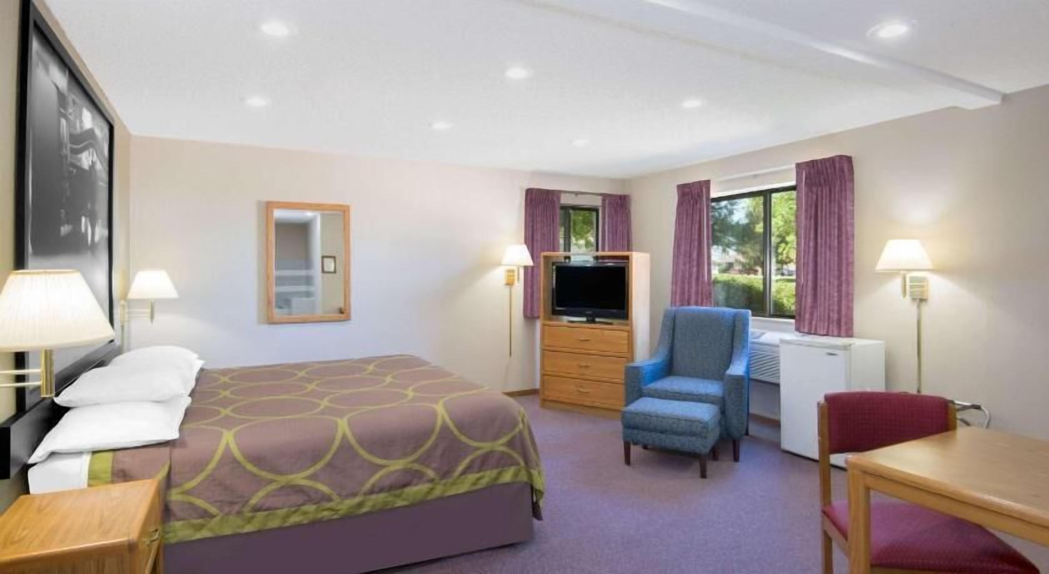 Premium bedding, desk, laptop workspace, blackout drapes