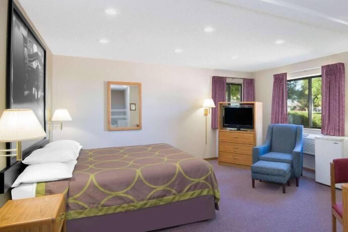 Premium bedding, desk, laptop workspace, blackout drapes