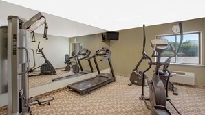 A hotel fitness center with treadmills, an elliptical, and a weight machine. - Baymont by Wyndham Jackson (Jackson)