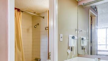 A bathroom with a bathtub, toilet, and sink.