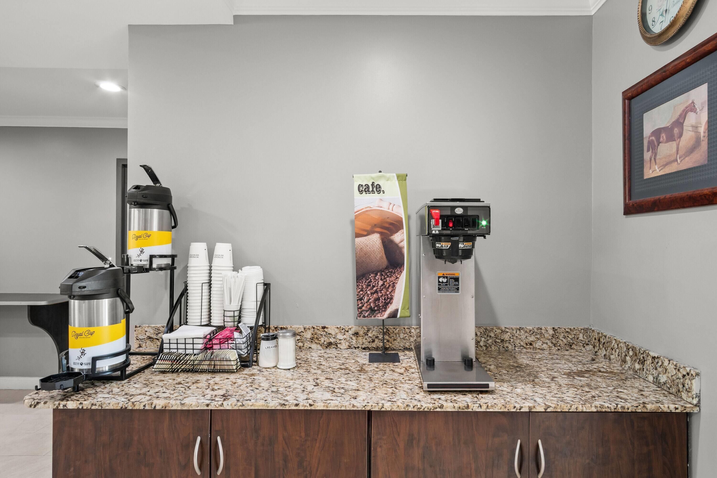 Eine Kaffeestation mit Kaffeemaschine, Einwegbechern und Kaffeeautomat.