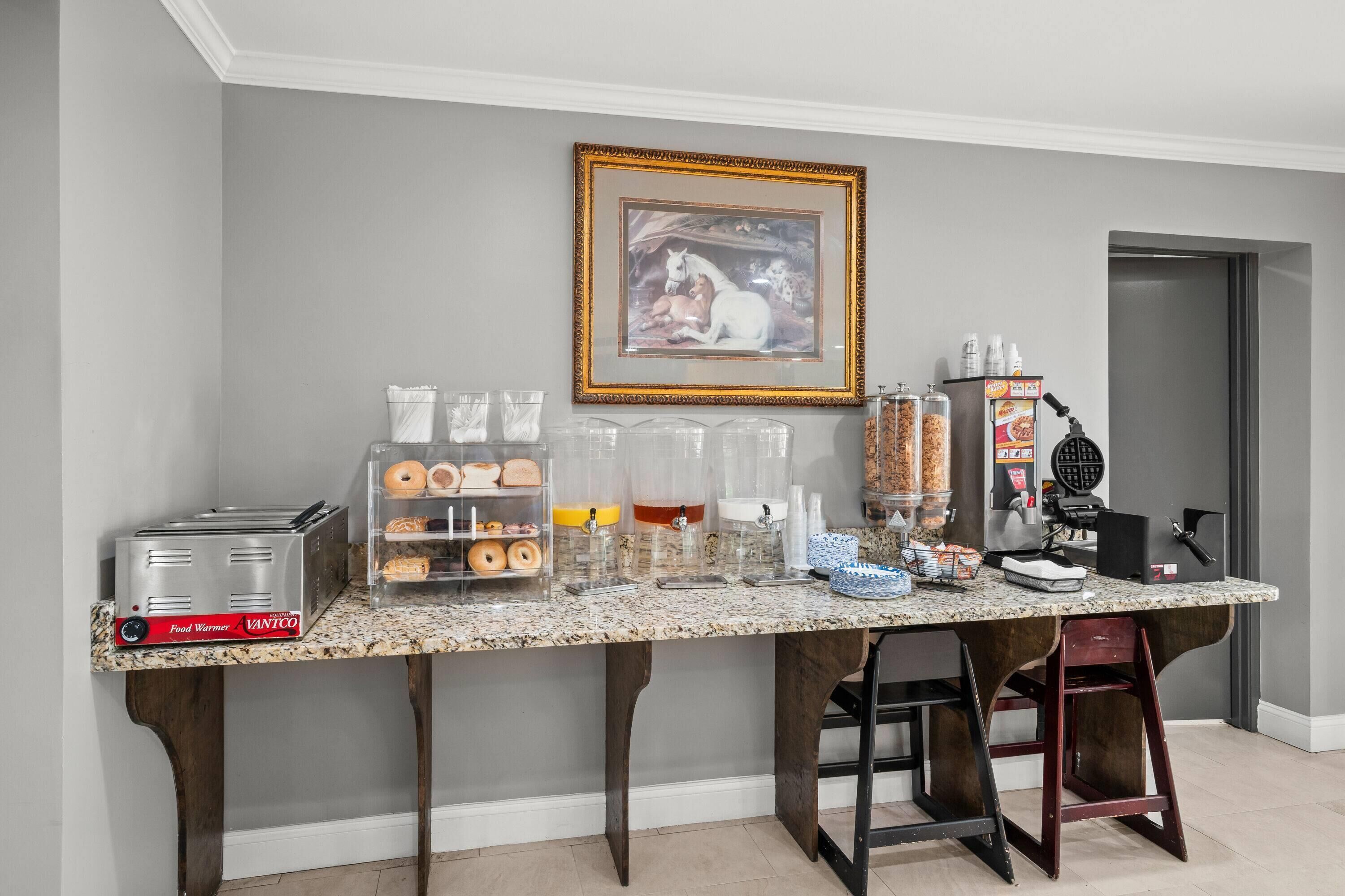 A breakfast bar with a toaster, coffee maker, and various food items.