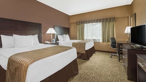 A hotel room with two beds, a desk, a chair, and a television. - Ramada Hotel & Conference Center by Wyndham Paintsville (Paintsville)