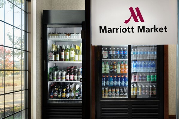 A refrigerated display case with various beverages, including alcohol and sodas, in a Marriott Market. - Minneapolis Marriott Northwest Hotel & Conference Center (Brooklyn Park)