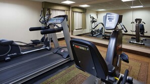 A gym with cardio machines, including a treadmill and an elliptical, and a mirrored wall. - La Quinta Inn by Wyndham Minneapolis Airport Bloomington (Bloomington)