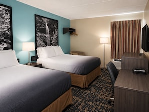 A hotel room with two beds, a desk, a chair, a TV, a lamp, and a coat rack. - Americas Best Value Inn Knoxville Downtown North (Knoxville)