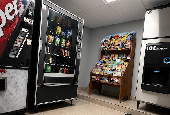 A vending machine area with a selection of snacks and a display of magazines.