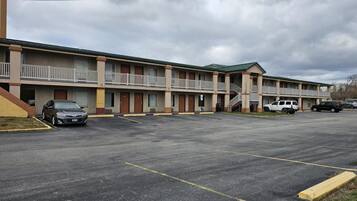 A motel with multiple rooms, a parking lot, and a covered walkway.
