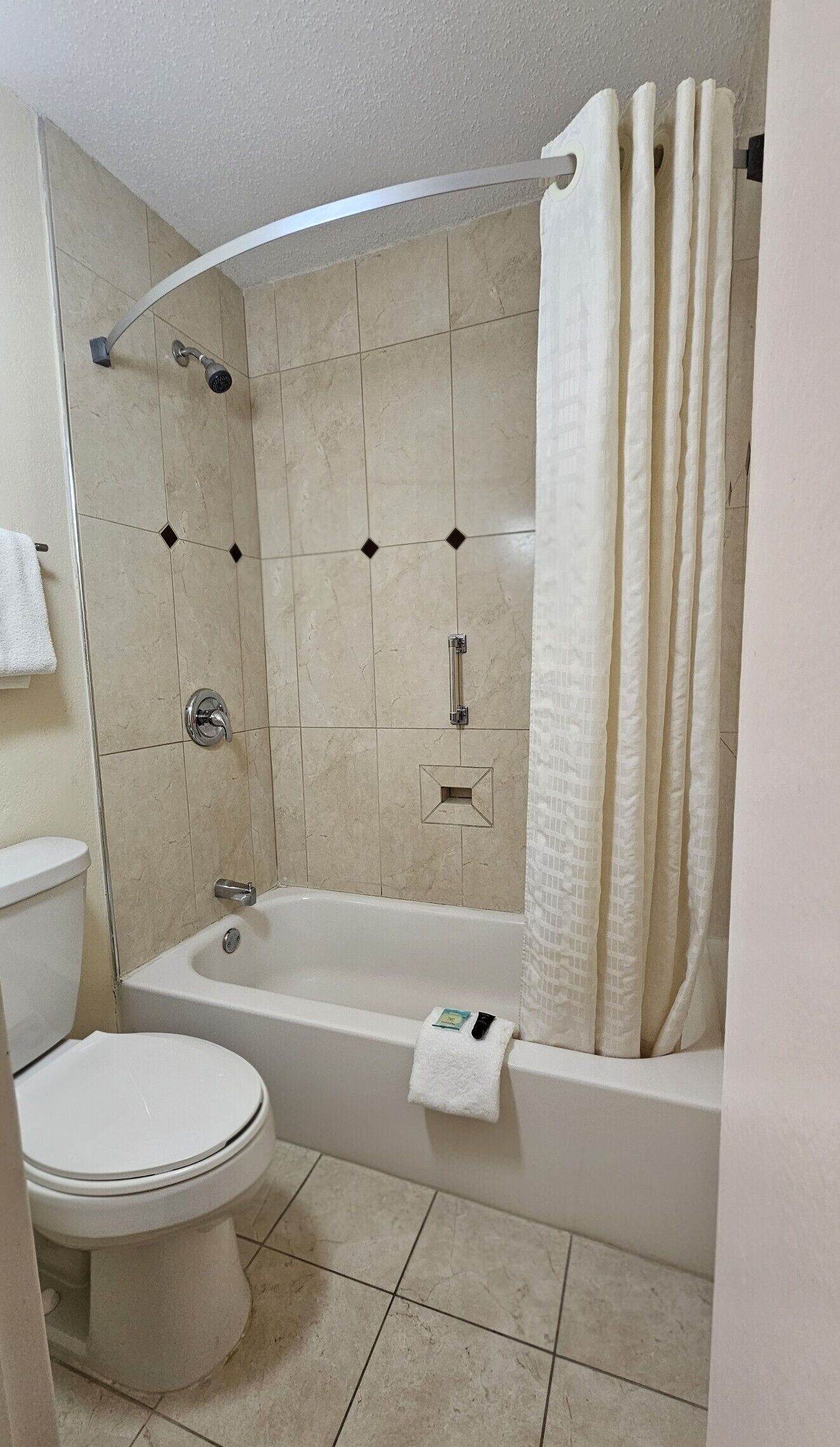 A bathroom with a bathtub, toilet, and shower.