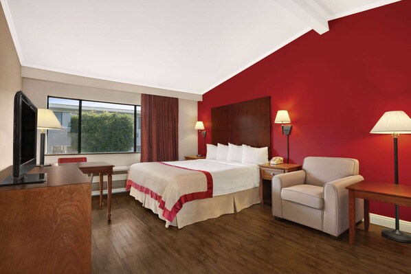 Relax in a stylish room with a large bed, desk, and flat-screen TV.