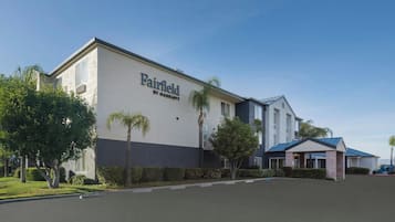 A Fairfield by Marriott hotel with a modern facade, a covered entrance, and a parking lot.