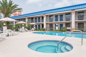 Outdoor pool, open 10:00 AM to 10:00 PM, pool umbrellas