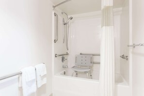 Enjoy a refreshing shower experience with a walk-in shower featuring a handheld and fixed showerhead.